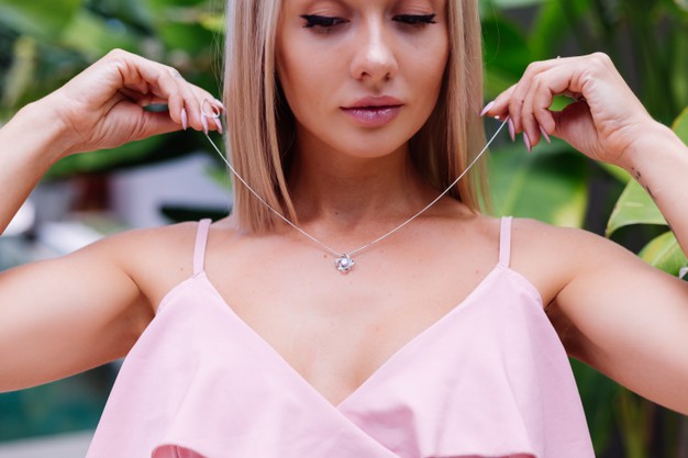 outdoor-portrait-woman-pink-romantic-dress-wearing-necklace_343596-1990